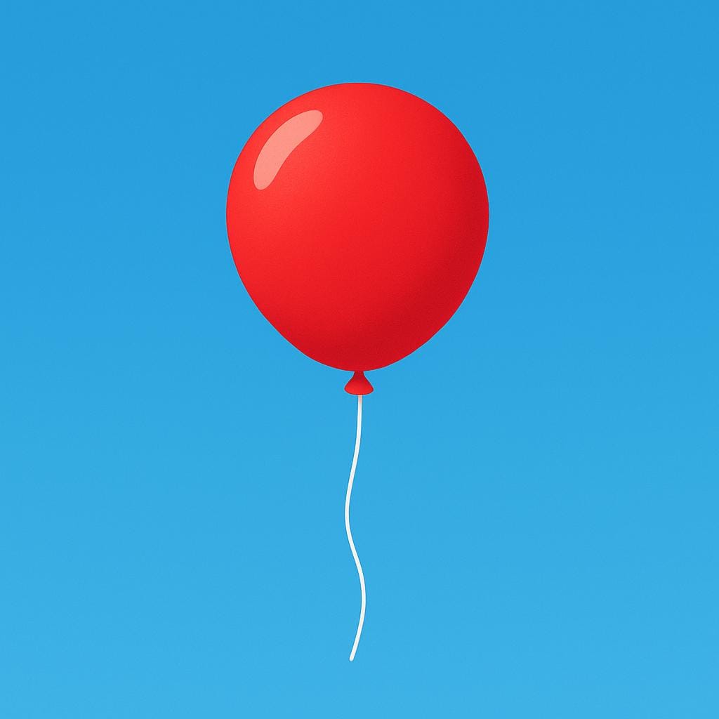 A bright red helium balloon floating high against a clear blue sky.