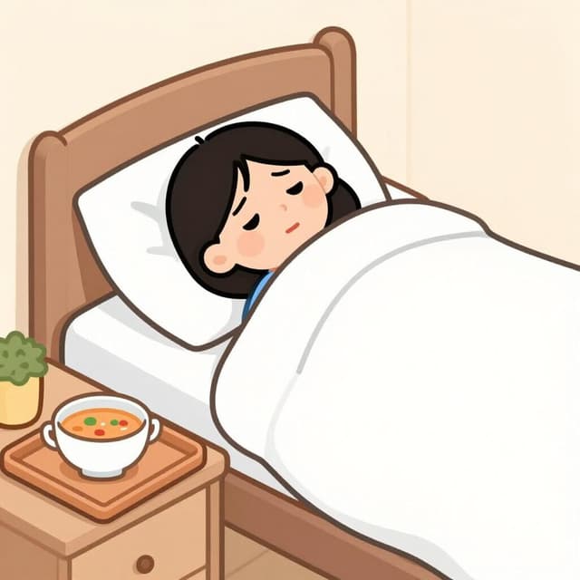 A sad person tucked into bed with a thermometer and a bowl of soup, looking unwell again.
